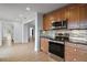 Spacious kitchen featuring wooden cabinets, tile backsplash, stainless steel appliances and lots of counter space at 502 Lake Gracie Dr, Eustis, FL 32726