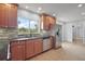 Kitchen with stainless steel appliances, tiled backsplash, sink, and window with view into the yard at 502 Lake Gracie Dr, Eustis, FL 32726