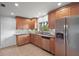 Well-lit kitchen featuring stainless steel appliances and light brown cabinets at 502 Lake Gracie Dr, Eustis, FL 32726