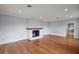 Hardwood floors and a fireplace adorn this freshly painted, well-lit living space at 502 Lake Gracie Dr, Eustis, FL 32726