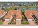 Beautiful aerial view showcases red tile roof and waterfront views with lush landscaping at 5056 Harbour Dr, Oxford, FL 34484
