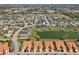 Expansive aerial view of a residential neighborhood with a mix of home styles and a scenic lake at 5056 Harbour Dr, Oxford, FL 34484