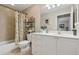 Bright bathroom featuring white cabinets, a toilet, a bathtub and a shower at 5056 Harbour Dr, Oxford, FL 34484
