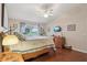 Comfortable bedroom featuring hardwood floors, soft lighting, and large windows at 5056 Harbour Dr, Oxford, FL 34484