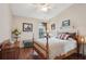 Cozy bedroom with a wood-frame bed, soft lighting and a decorative floral arrangement at 5056 Harbour Dr, Oxford, FL 34484
