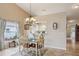 Dining room features decorative chandelier, tile floors, and ample natural light from a nearby window at 5056 Harbour Dr, Oxford, FL 34484