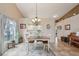 Bright dining area features a chandelier, large windows and an open view into the kitchen at 5056 Harbour Dr, Oxford, FL 34484