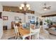 Open dining room and living area featuring a chandelier and adjacent sitting area at 5056 Harbour Dr, Oxford, FL 34484