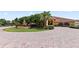 A circle drive with brick pavers leads to a well landscaped home with a fountain centerpiece at 5056 Harbour Dr, Oxford, FL 34484