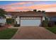 Inviting single Gathering home with a brick driveway leading to an attached two-car garage with a tile roof at 5056 Harbour Dr, Oxford, FL 34484