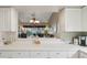 Bright kitchen with a pass through view of the open living space with vaulted ceilings at 5056 Harbour Dr, Oxford, FL 34484