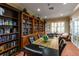 Inviting library with floor-to-ceiling bookshelves and comfortable seating at 5056 Harbour Dr, Oxford, FL 34484