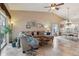 Spacious living room with vaulted ceilings, tile floors, comfortable seating and access to the screened lanai at 5056 Harbour Dr, Oxford, FL 34484