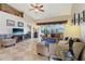Bright living room featuring comfortable seating, tile floors and expansive views of the screened lanai and pond at 5056 Harbour Dr, Oxford, FL 34484