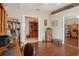 Inviting living room with hardwood floors, built-in shelving, and bright, open doorway at 5056 Harbour Dr, Oxford, FL 34484