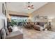 Open living room with vaulted ceiling, comfortable seating and an expansive view of the screened lanai and pond at 5056 Harbour Dr, Oxford, FL 34484