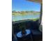 Relaxing patio with comfortable seating and a beautiful view of the lake at 5056 Harbour Dr, Oxford, FL 34484
