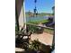 Enjoy lake views from this cozy patio space with brick flooring and decorative plants and furnishings at 5056 Harbour Dr, Oxford, FL 34484
