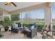 Beautiful screened-in lanai with comfortable chairs, great views, and lovely foliage at 5056 Harbour Dr, Oxford, FL 34484