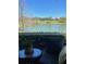 A close up view of the lanai, including comfortable seating and a beautiful lake view at 5056 Harbour Dr, Oxford, FL 34484