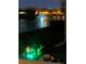 A tranquil water fountain and pond are lit up against the night sky at 5056 Harbour Dr, Oxford, FL 34484