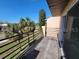 A home's balcony showcases a railing overlooking a lawn area with clear blue skies above at 5214 Via Hacienda Cir # A308, Orlando, FL 32839