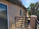 Balcony with exterior features including lighting fixture, sliding glass door and palm trees in the background at 5214 Via Hacienda Cir # A308, Orlando, FL 32839