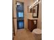This bathroom has a decorative mirror, vanity with storage, and toilet at 5214 Via Hacienda Cir # A308, Orlando, FL 32839