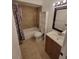 A bathroom featuring vanity, toilet, and shower/tub combo with curtain at 5214 Via Hacienda Cir # A308, Orlando, FL 32839