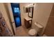 This bathroom has a decorative mirror, vanity with storage, and toilet at 5214 Via Hacienda Cir # A308, Orlando, FL 32839