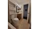 Bathroom features a decorative mirror, vanity with storage, and toilet at 5214 Via Hacienda Cir # A308, Orlando, FL 32839