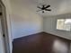 A bedroom with wood floors, ceiling fan, and window with natural light at 5214 Via Hacienda Cir # A308, Orlando, FL 32839
