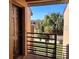 View of the front door showing the front door and railing with palm trees outside of the house at 5214 Via Hacienda Cir # A308, Orlando, FL 32839