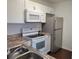 Well-equipped kitchen with white appliances, ample cabinet space, and sleek countertops at 5214 Via Hacienda Cir # A308, Orlando, FL 32839