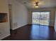 View of a living room featuring hardwood floors and a sliding glass door at 5214 Via Hacienda Cir # A308, Orlando, FL 32839