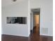 View of the living room showing access to kitchen and view down the hall with dark wood floors at 5214 Via Hacienda Cir # A308, Orlando, FL 32839