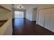 Bright living room with dark wood floors, closet, ceiling fan, and sliding door to the balcony at 5214 Via Hacienda Cir # A308, Orlando, FL 32839