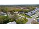 Aerial view showcasing a neighborhood with a natural preserve in the distance at 5402 Rosewall Cir, Leesburg, FL 34748
