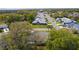 Wide aerial view of a residential neighborhood showing tree lined streets with sidewalks at 5402 Rosewall Cir, Leesburg, FL 34748