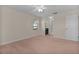A light-filled bedroom features neutral walls, carpet, and a view to an en-suite bathroom at 5402 Rosewall Cir, Leesburg, FL 34748