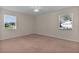 Cozy bedroom with twin windows bringing in natural light and neighborhood views at 5402 Rosewall Cir, Leesburg, FL 34748