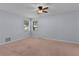 Bright bedroom with carpet, ceiling fan, two windows and light-blue walls at 5402 Rosewall Cir, Leesburg, FL 34748