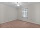 Bright bedroom with ceiling fan, neutral walls, and a window at 5402 Rosewall Cir, Leesburg, FL 34748