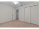 Bedroom with neutral carpet, featuring closet and door to adjacent room at 5402 Rosewall Cir, Leesburg, FL 34748