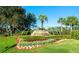 Community entrance sign with water feature and lush landscaping at 5402 Rosewall Cir, Leesburg, FL 34748