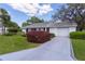 Home with a well-kept lawn, a driveway, and a two-car garage at 5402 Rosewall Cir, Leesburg, FL 34748