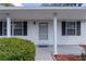 Charming home entrance with white columns, neat landscaping and neutral front door at 5402 Rosewall Cir, Leesburg, FL 34748