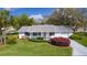 Charming single-story home featuring a well-manicured lawn and colorful landscaping for excellent curb appeal at 5402 Rosewall Cir, Leesburg, FL 34748