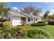 Charming home with well-maintained lawn, flowers, shrubs, and mature trees at 5402 Rosewall Cir, Leesburg, FL 34748