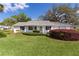 Landscaped front yard showcasing lush green grass and mature landscaping at 5402 Rosewall Cir, Leesburg, FL 34748